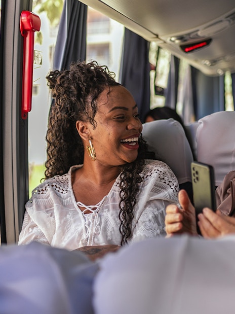 Customers smiling on air-conditioned bus during Herculaneum tour from Naples.