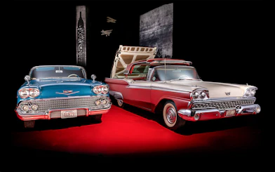 Classic cars display at Technik Museum Sinsheim with vintage license plates.