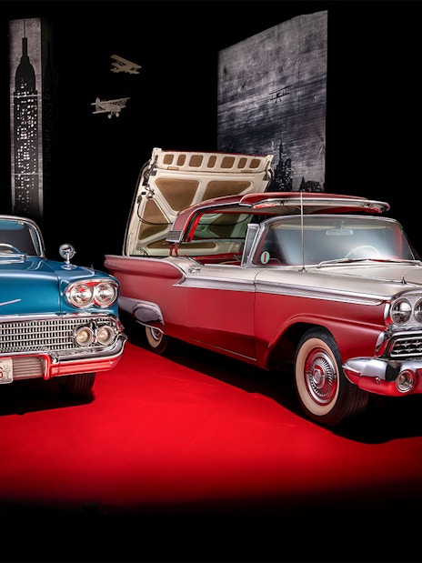 Classic cars display at Technik Museum Sinsheim with vintage license plates.