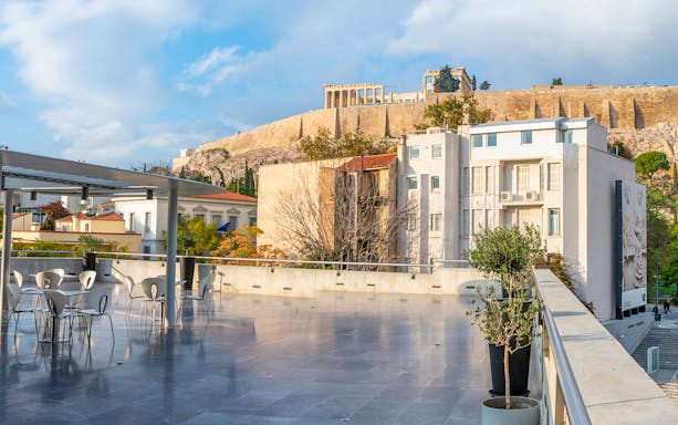 Acropolis view from a terrace in Athens, Greece, with Parthenon in the background.