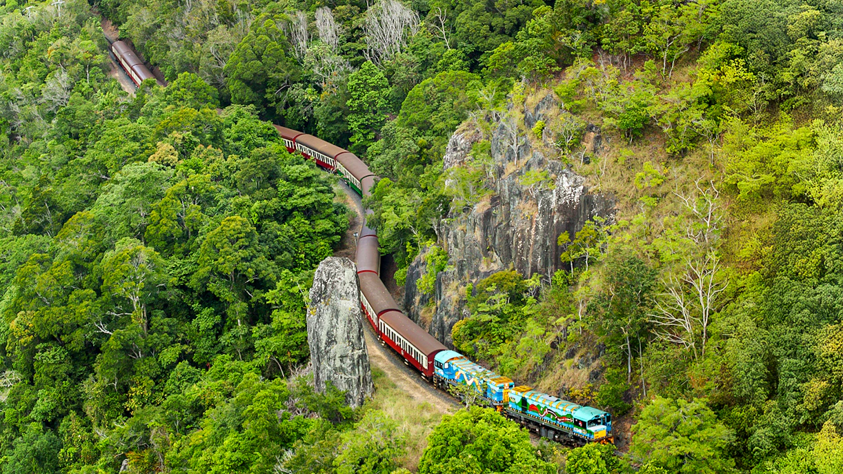 Kuranda Scenic Railway winding through lush rainforest in Queensland.