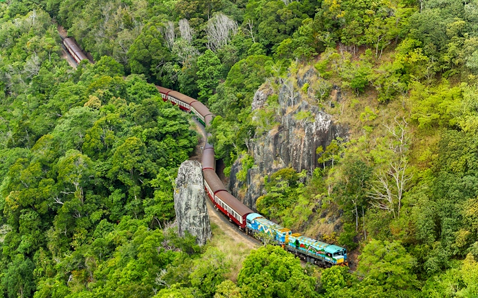 Kuranda Scenic Railway winding through lush rainforest in Queensland.