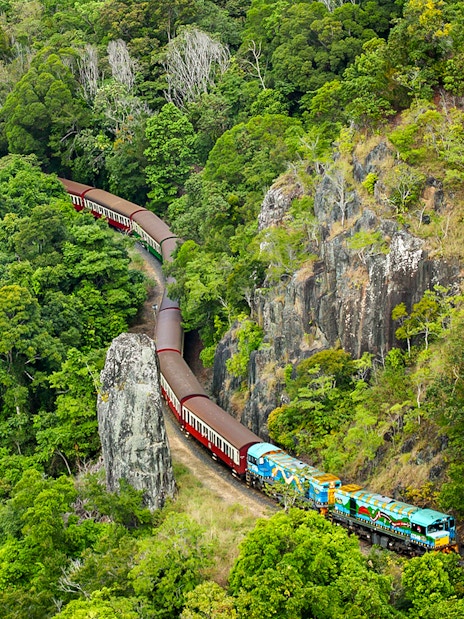 Kuranda Scenic Railway winding through lush rainforest in Queensland.