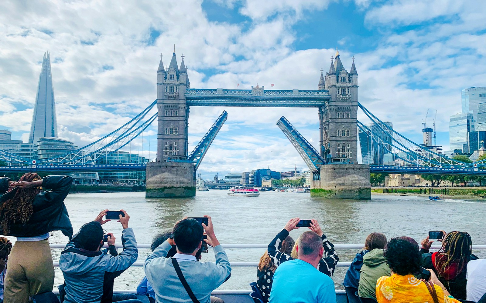 Tower Bridge and Thames River cruise boat in London.