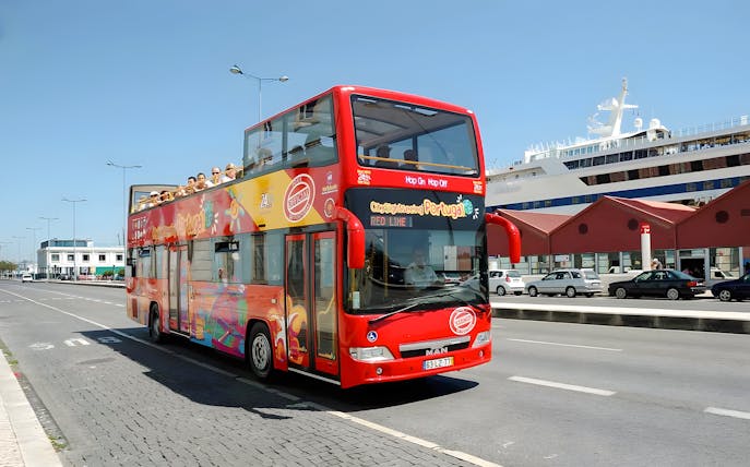 Lisbon hop-on hop-off sightseeing bus on city street near cruise ship terminal.