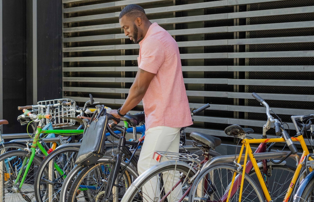 Amsterdam cityscape with rows of parked bicycles along a canal.