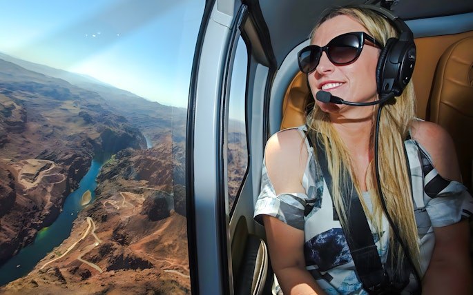 Guest enjoying aerial view of Grand Canyon West Rim from helicopter, Las Vegas tour.