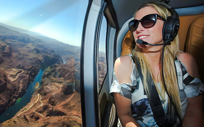 Guest enjoying aerial view of Grand Canyon West Rim from helicopter, Las Vegas tour.