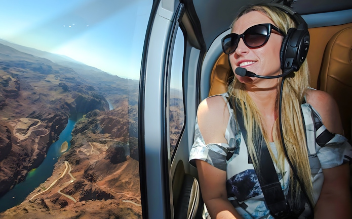 Guest enjoying aerial view of Grand Canyon West Rim from helicopter, Las Vegas tour.