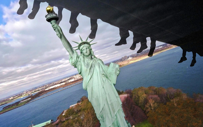 Guests on a ride at RiseNY with a view of the Statue of Liberty.