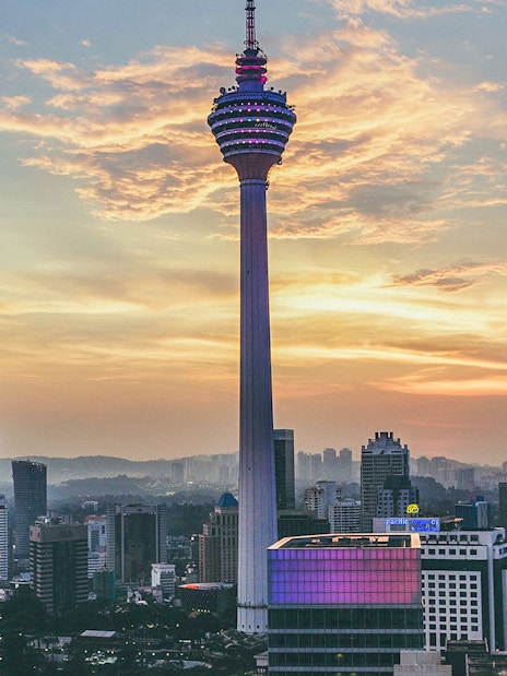 KL Tower at sunset with city skyline, Kuala Lumpur.