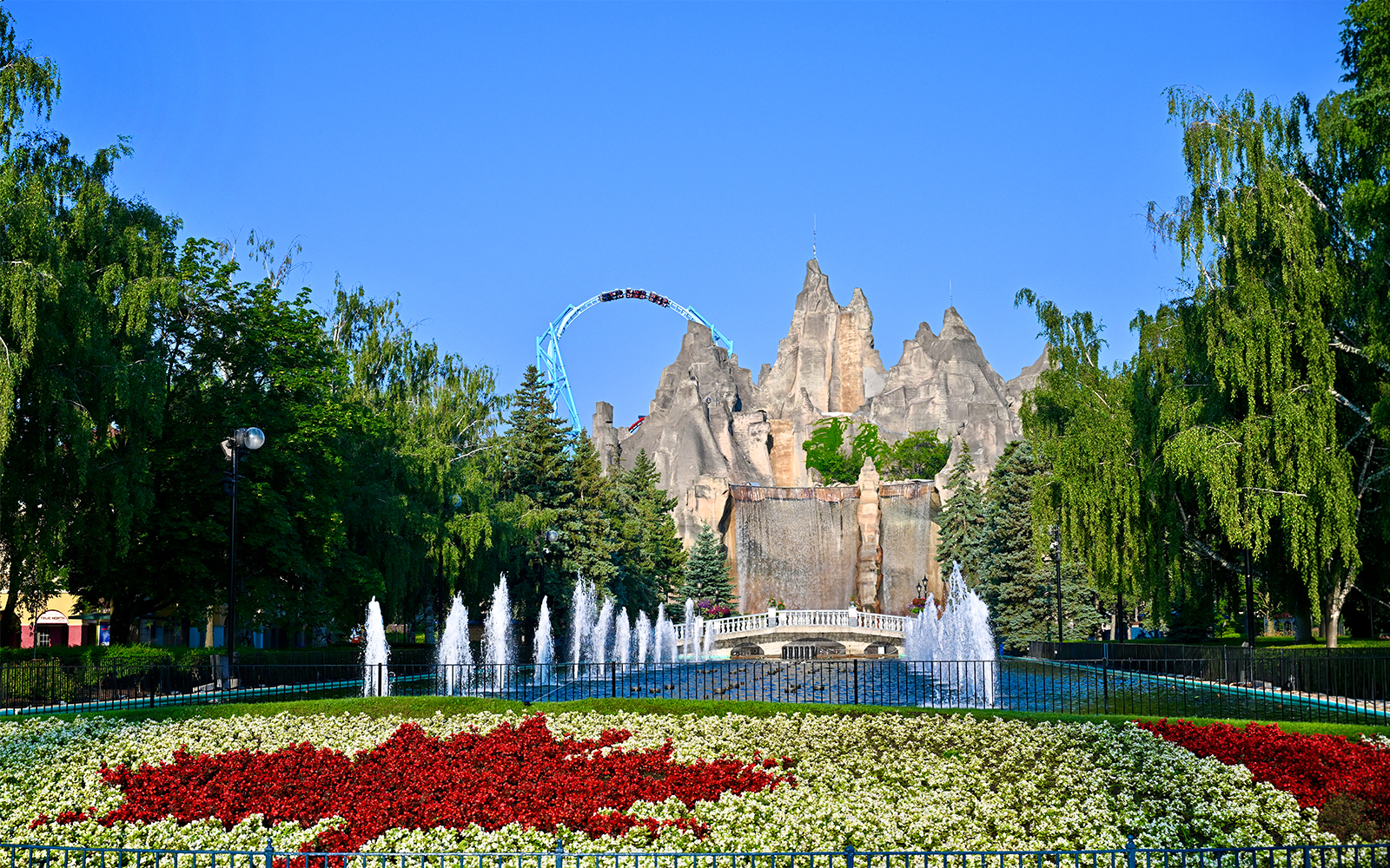 Wonder Mountain and floral display at Canada's Wonderland with roller coaster in background.