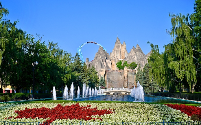 Wonder Mountain and floral display at Canada's Wonderland with roller coaster in background.