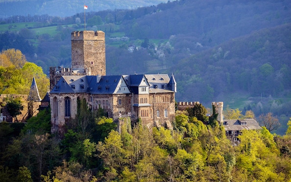Marksburg Castle surrounded by lush greenery near Koblenz, Germany.