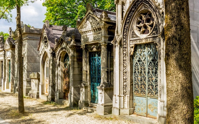 Mausoleums with ornate ironwork at Père Lachaise Cemetery, Paris.