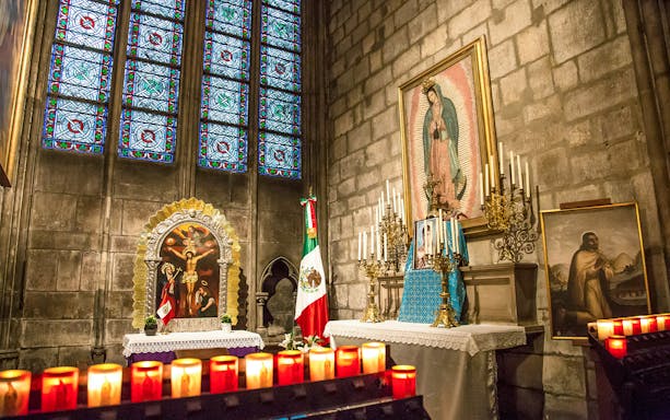 Notre Dame Paris chapel interior with stained glass and religious icons.