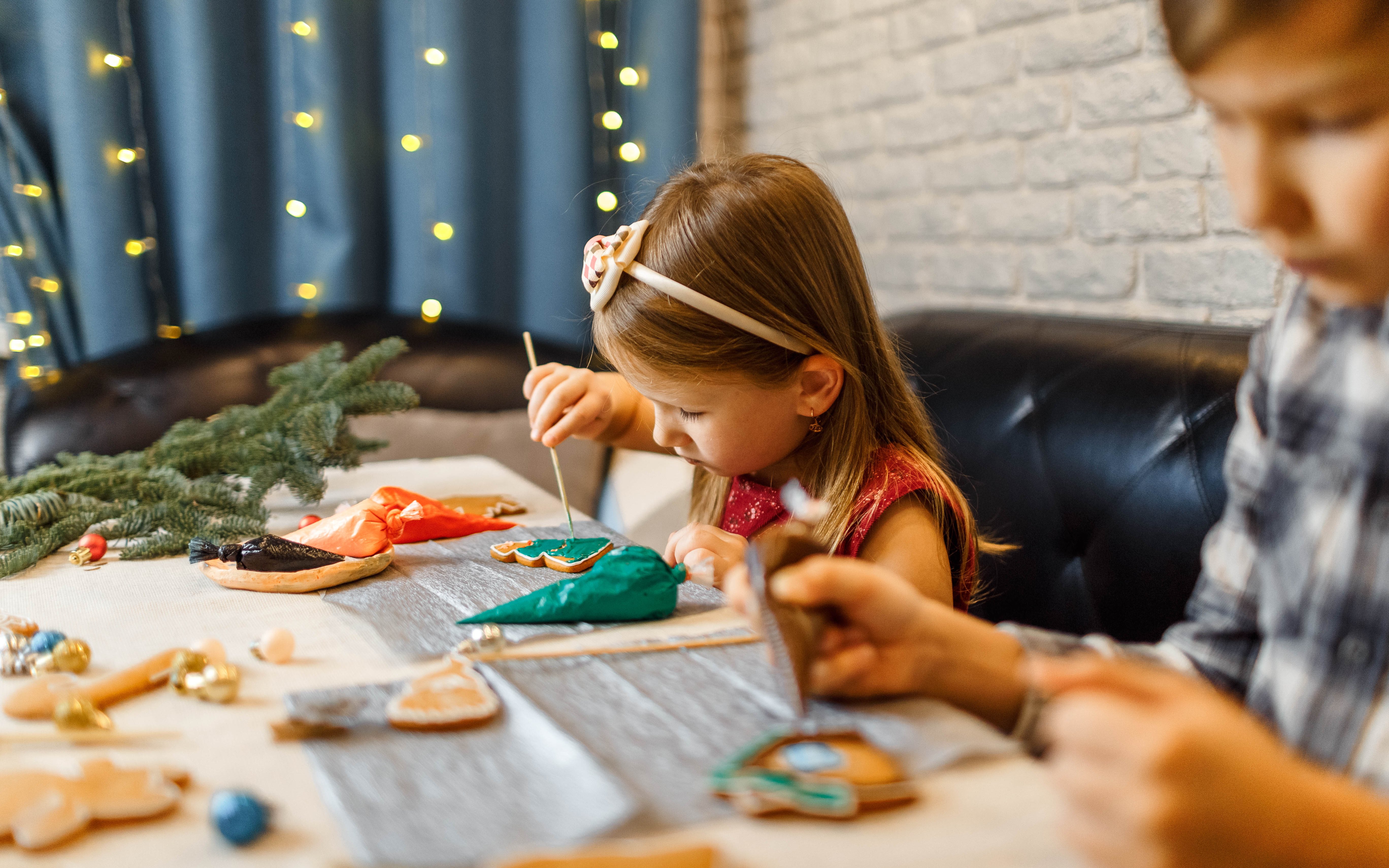 Children decorate gingerbread cookies, Christmas activity