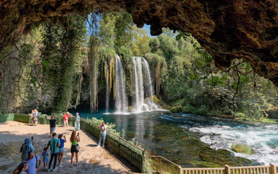 Waterfall view with tourists in Antalya during sightseeing city tour.