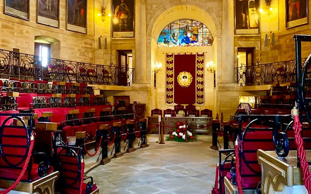 Gernika Assembly House interior with stained glass and red seating, part of San Sebastian tour.