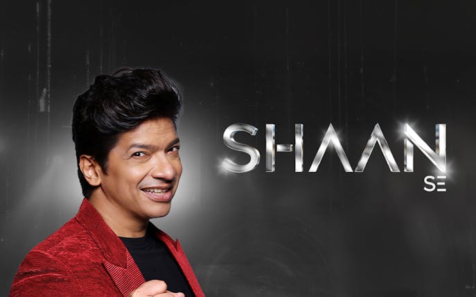 Performer in red jacket promoting Shaan Se concert at Coca-Cola Arena, Dubai
