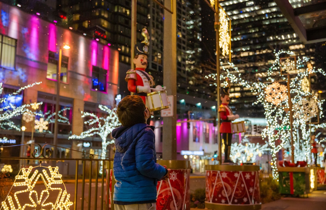 Boy admiring festive Christmas lights and decorations in downtown Seattle.