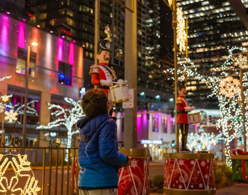 Boy admiring festive Christmas lights and decorations in downtown Seattle.