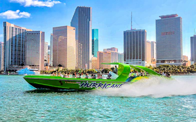 Speedboat named Hurricane cruising past Miami skyline.