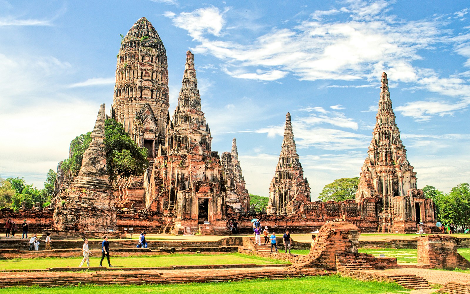 Ayutthaya Historical Park temple ruins with tourists exploring the site.