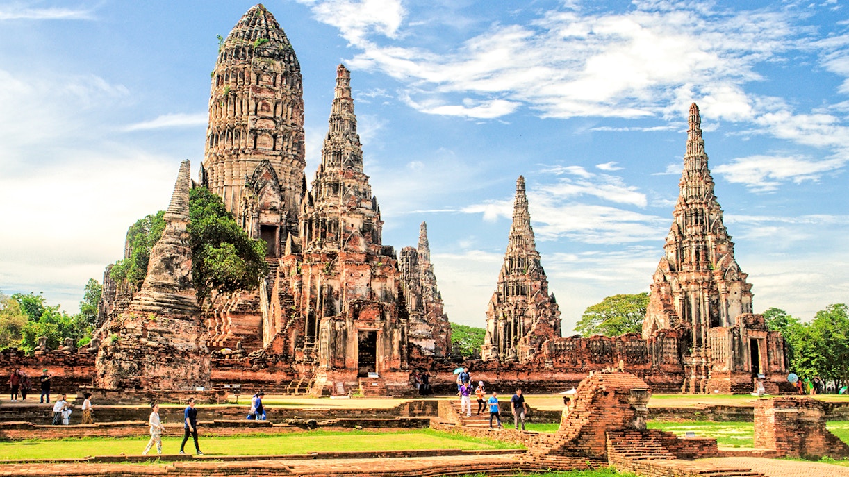 Ayutthaya Historical Park temple ruins with tourists exploring the site.