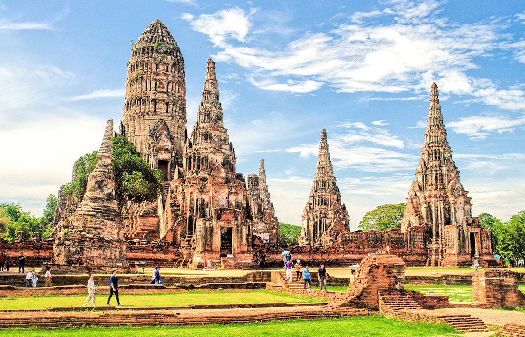 Ayutthaya Historical Park temple ruins with tourists exploring the site.