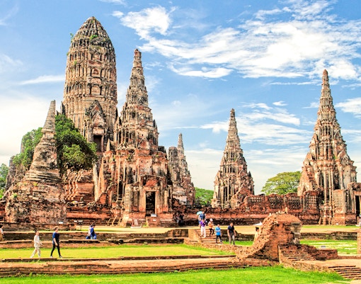 Ayutthaya Historical Park temple ruins with tourists exploring the site.