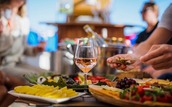 Wine glass and appetizers on a luxury cruise in Amsterdam.