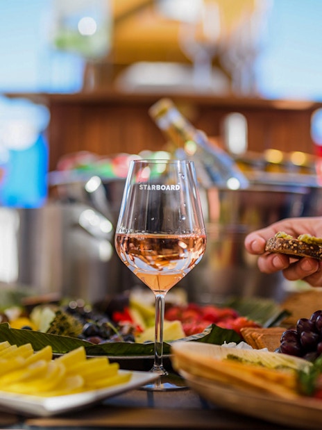 Wine glass and appetizers on a luxury cruise in Amsterdam.