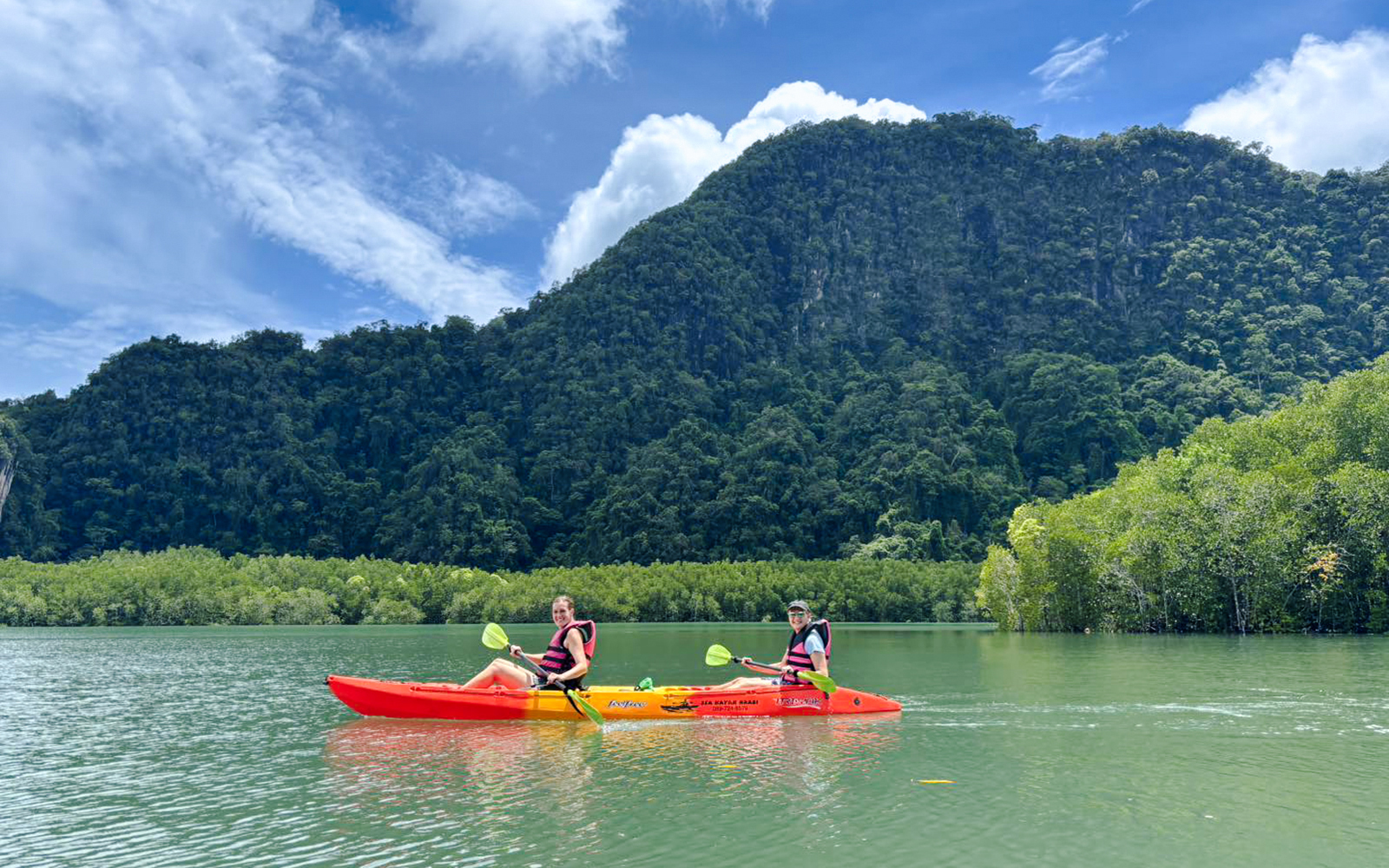 Tourists kayaking at Ao Thalane through mangrove forests in Thailand.
