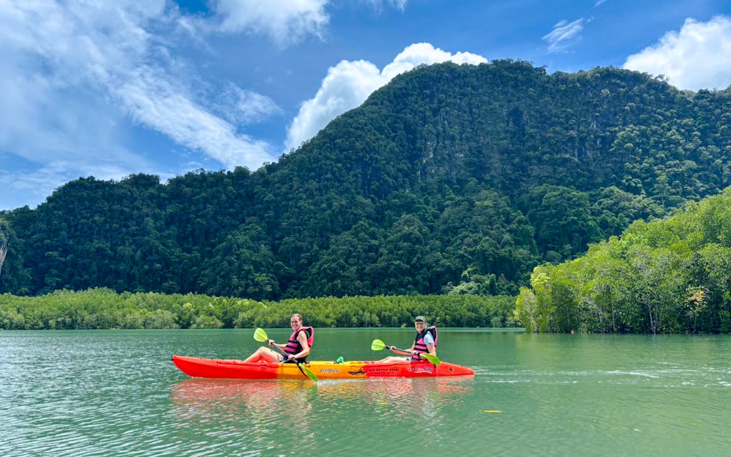 Tourists kayaking at Ao Thalane through mangrove forests in Thailand.