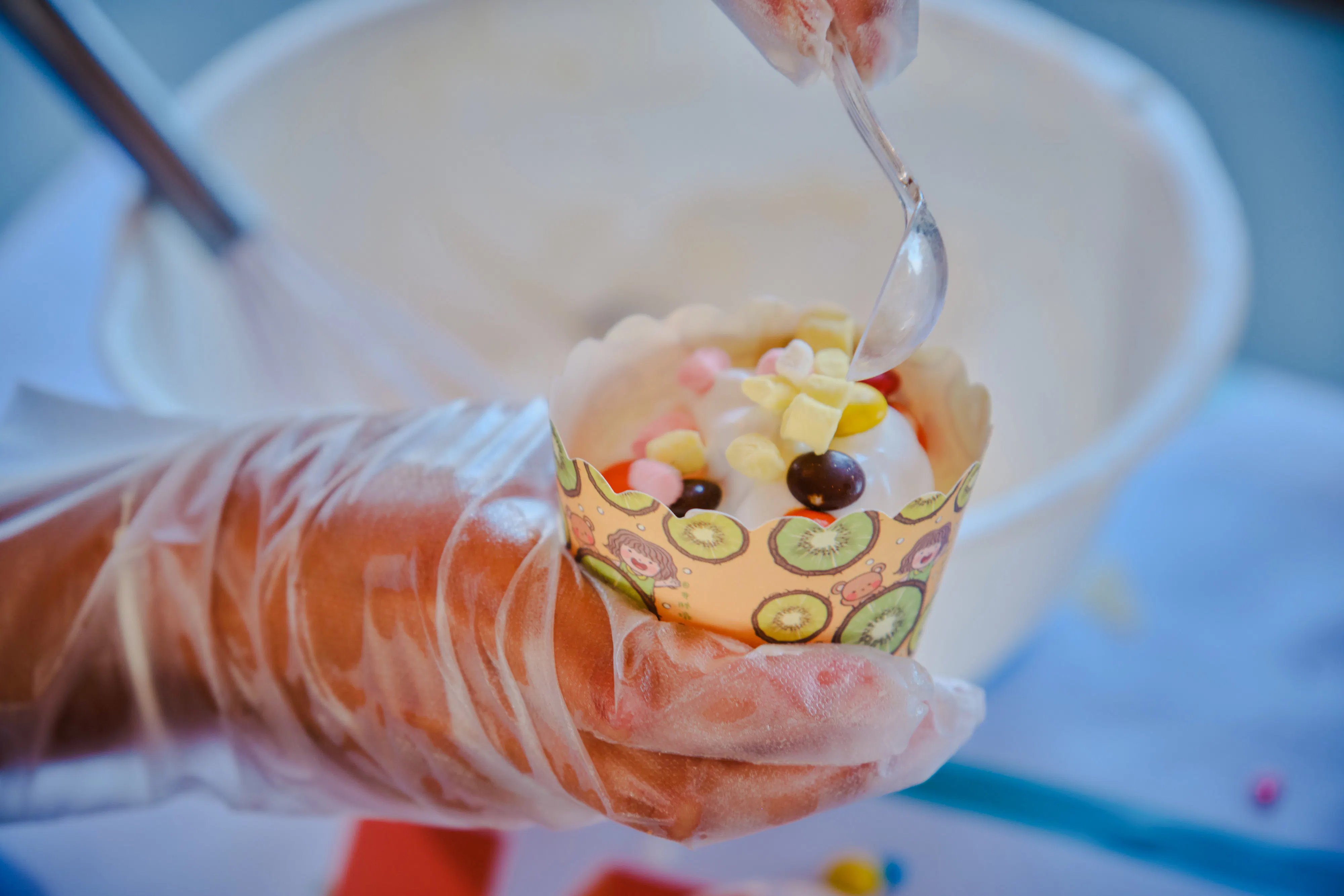 Decorating a cupcake with colorful toppings during a birthday party in Phuket.