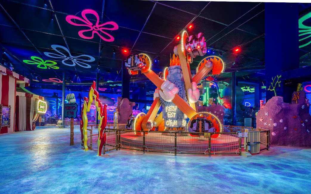 Colorful ride at Nickland in The Land of Legends theme park, featuring vibrant lights and decorations.