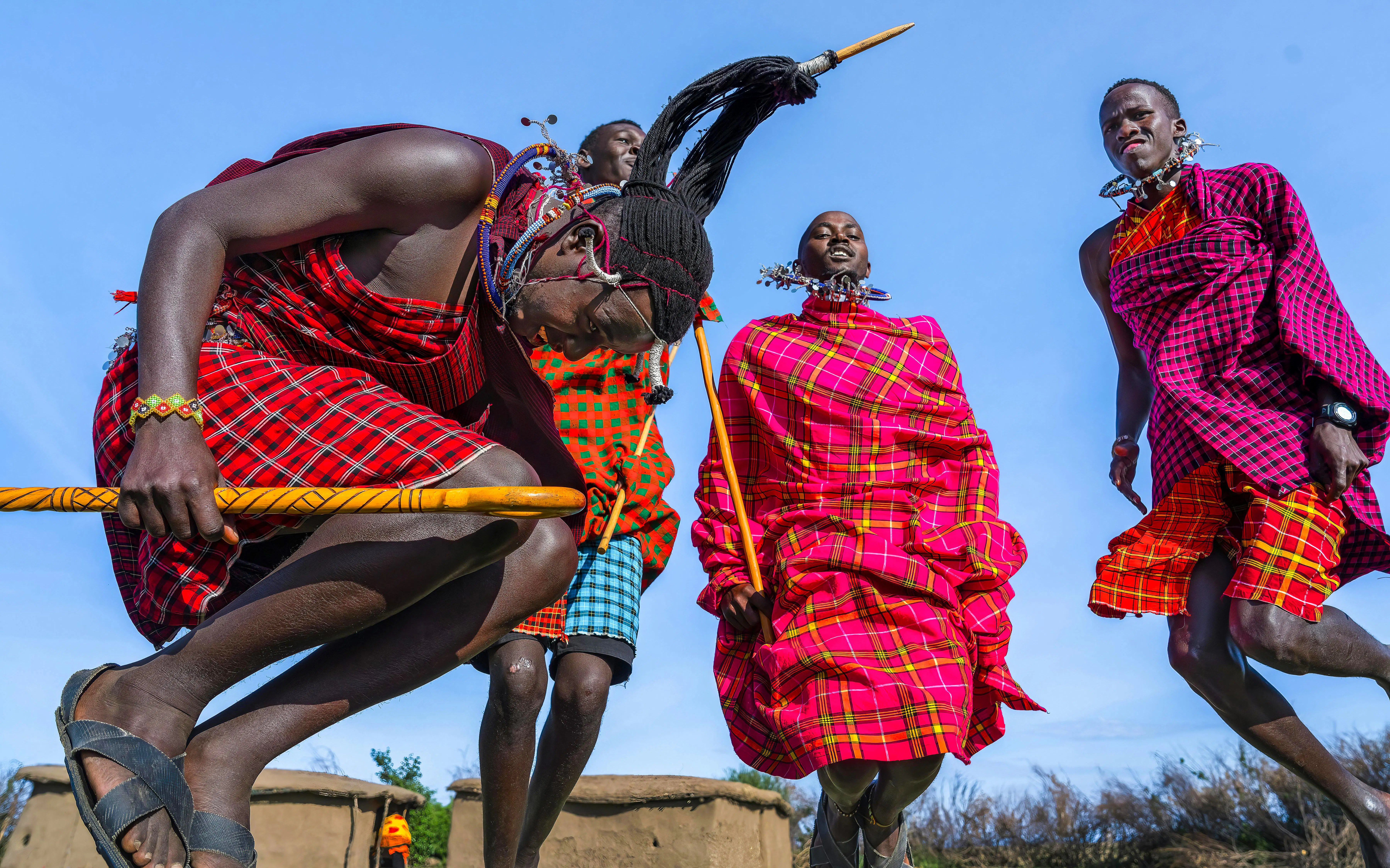 Maasai men performing traditional jumping dance in Maasai Mara, Kenya.