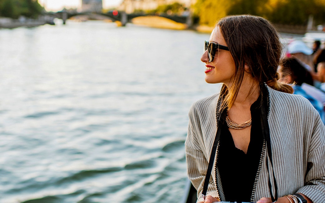Tourist enjoying a boat ride on Hamburg's Elbe River during a harbor tour.
