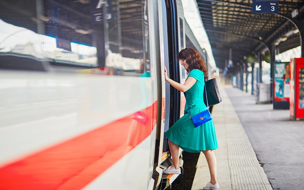 Passenger boarding train at Naples Porta Nolana station for Herculaneum transfer.