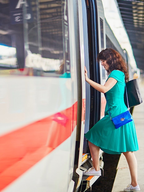 Passenger boarding train at Naples Porta Nolana station for Herculaneum transfer.