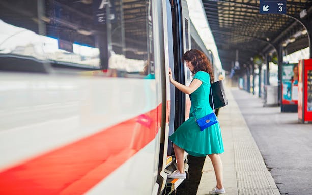 Passenger boarding train at Naples Porta Nolana station for Herculaneum transfer.