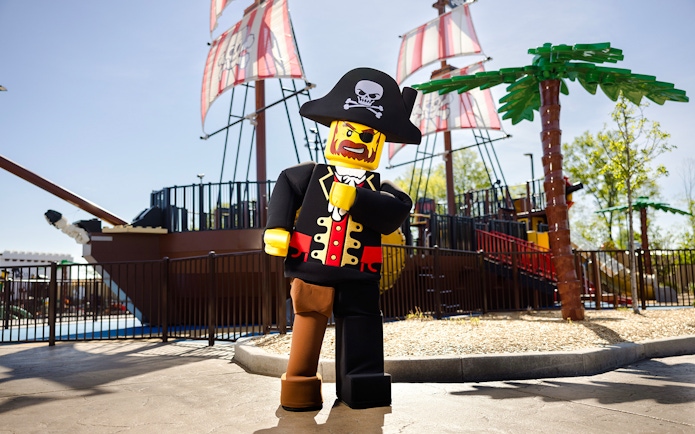 Lego pirate character in front of a pirate ship at Legoland New York.