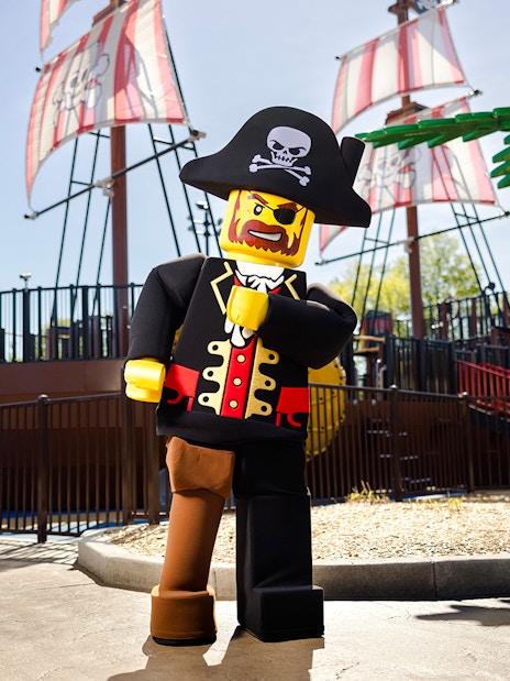 Lego pirate character in front of a pirate ship at Legoland New York.