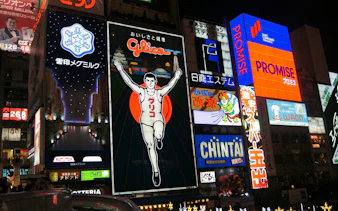 Dotonbori neon signs at night, featuring the Glico running man, Osaka street food tour.