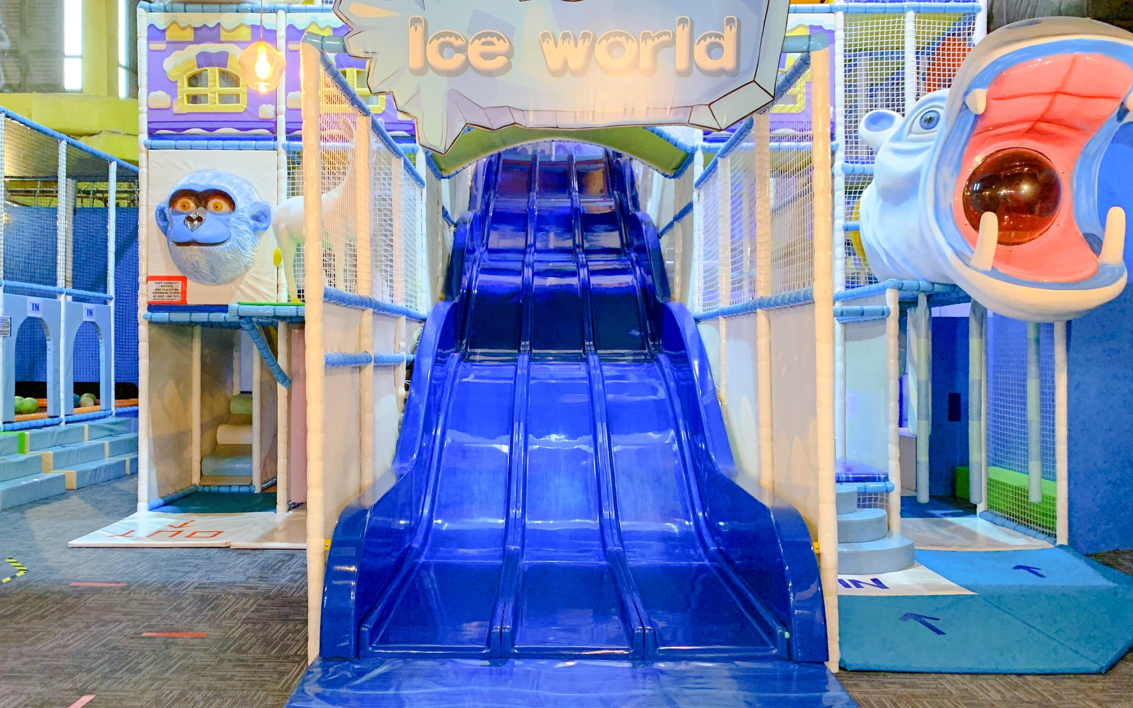 Indoor playground slide at Amazonia Singapore with animal-themed decor.