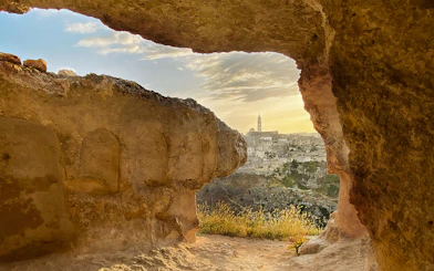 View of Matera's ancient cityscape through a cave opening during a 2-hour guided tour.