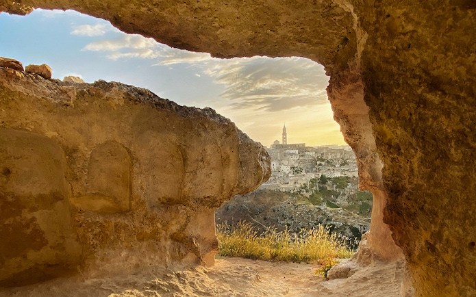 View of Matera's ancient cityscape through a cave opening during a 2-hour guided tour.