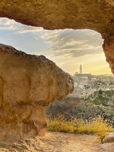 View of Matera's ancient cityscape through a cave opening during a 2-hour guided tour.