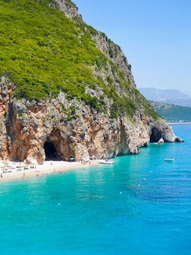 Pirates cave near Gjipe Beach, Albania with turquoise water and rocky cliffs in summer.